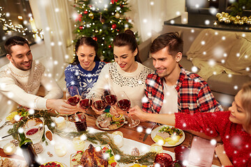 Image showing friends celebrating christmas and drinking wine