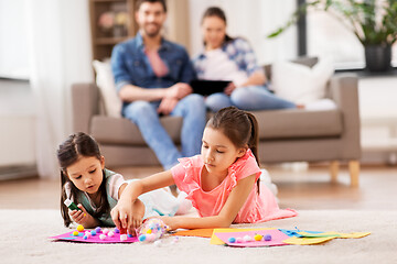 Image showing happy sisters doing arts and crafts at home