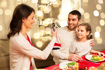 Image showing happy family taking picture at christmas dinner