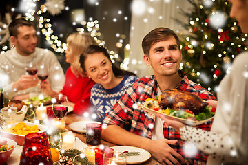 Image showing happy friends having christmas dinner at home