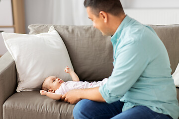 Image showing middle aged father playing with baby at home