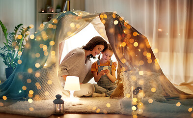 Image showing happy family with smartphone in kids tent at home