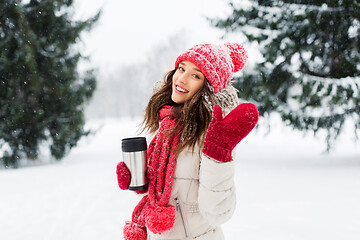 Image showing young woman with hot drink in tumbler in winter