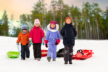 Image showing happy little kids with sleds in winter