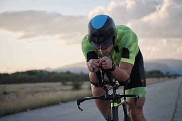 Image showing triathlon athlete riding a bike