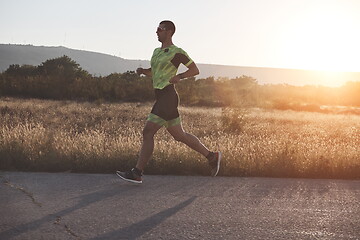 Image showing triathlon athlete running on morning trainig