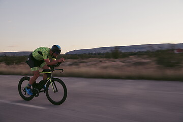 Image showing triathlon athlete riding a bike