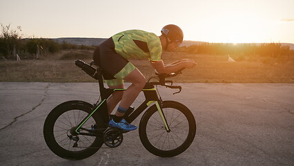 Image showing triathlon athlete riding a bike