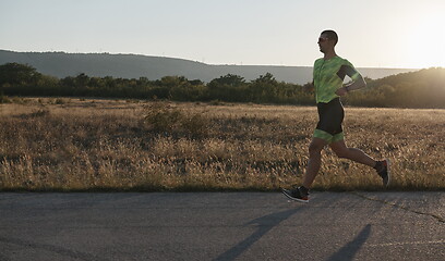 Image showing triathlon athlete running on morning trainig