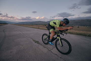 Image showing triathlon athlete riding a bike