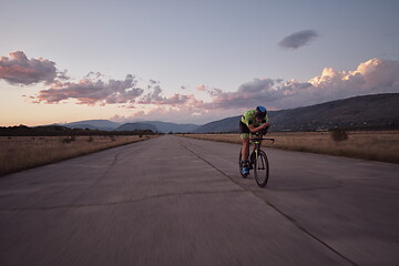 Image showing triathlon athlete riding a bike