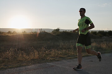 Image showing triathlon athlete running on morning trainig