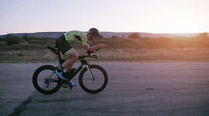 Image showing triathlon athlete riding a bike