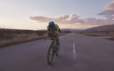 Image showing triathlon athlete riding a bike