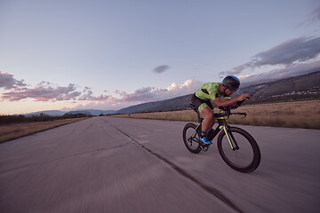 Image showing triathlon athlete riding a bike