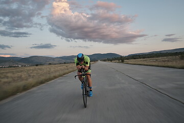 Image showing triathlon athlete riding a bike