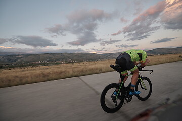 Image showing triathlon athlete riding a bike