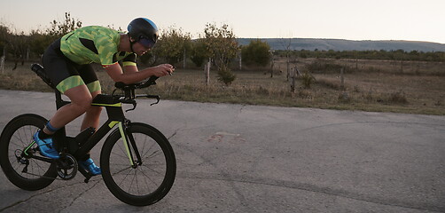 Image showing triathlon athlete riding a bike