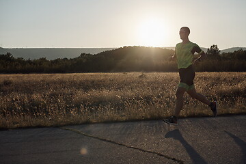 Image showing triathlon athlete running on morning trainig