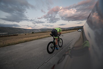 Image showing triathlon athlete riding a bike