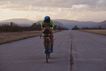 Image showing triathlon athlete riding a bike