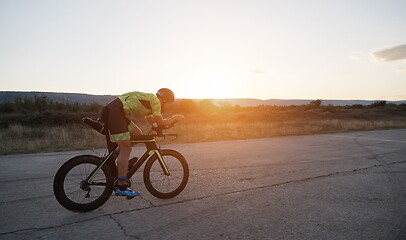 Image showing triathlon athlete riding a bike