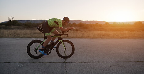 Image showing triathlon athlete riding a bike