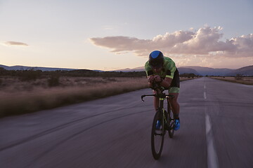 Image showing triathlon athlete riding a bike