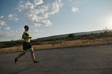 Image showing triathlon athlete running on morning trainig