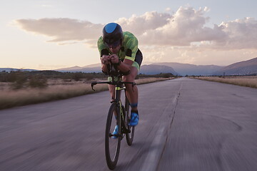 Image showing triathlon athlete riding a bike