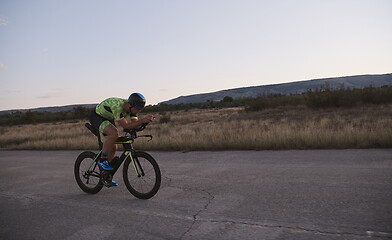 Image showing triathlon athlete riding a bike