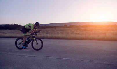 Image showing triathlon athlete riding a bike