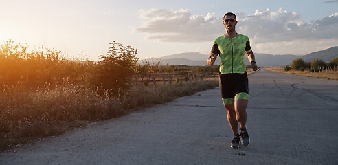 Image showing triathlon athlete running on morning trainig