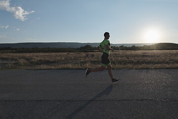 Image showing triathlon athlete running on morning trainig