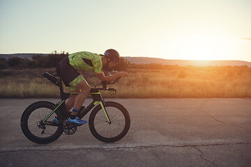 Image showing triathlon athlete riding a bike