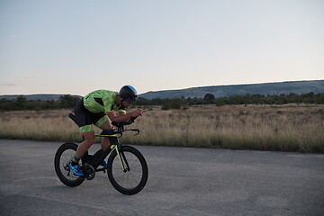 Image showing triathlon athlete riding a bike