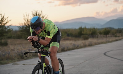 Image showing triathlon athlete riding a bike