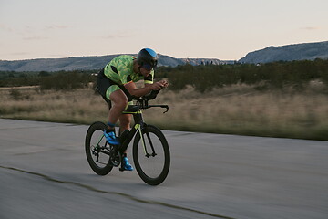 Image showing triathlon athlete riding a bike