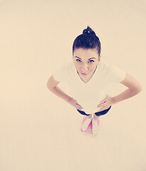 Image showing happy diet concept with young woman on pink scale