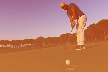 Image showing golfer  hitting shot at golf course