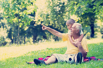 Image showing grandfather and child have fun  in park