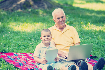 Image showing grandfather and child using laptop