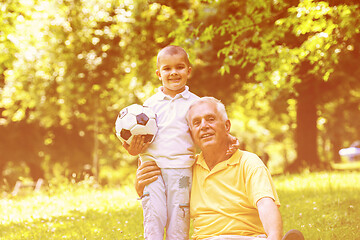 Image showing grandfather and child in park using tablet