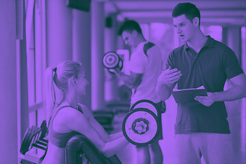 Image showing young sporty woman with trainer exercise weights lifting