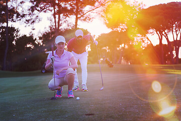 Image showing couple on golf course at sunset