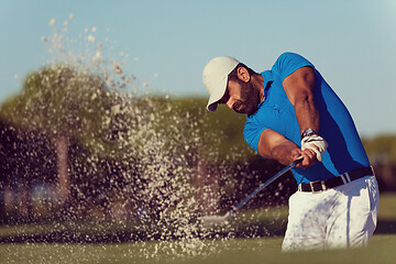 Image showing pro golfer hitting a sand bunker shot