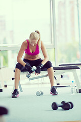 Image showing young woman exercise with dumbells