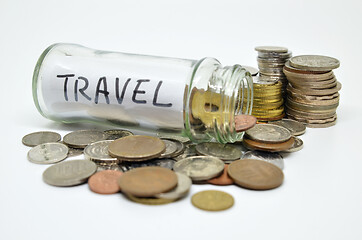 Image showing Travel lable in a glass jar with coins spilling out