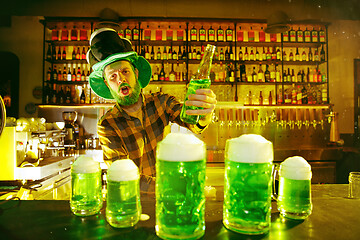 Image showing Happy man with glass of beer looking aside in pub