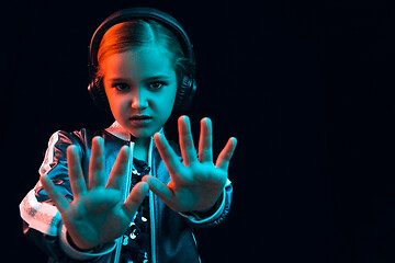 Image showing Young girl with headphones enjoying music